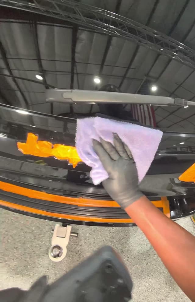 Wiping off polish residue with a microfiber towel, during training